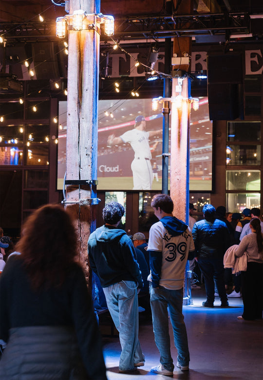 A crowd watching the Jays game on a big projection screen at the Steamwhistle Brewery