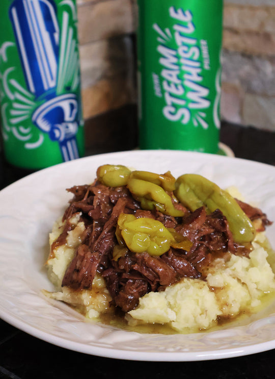 A Mississippi beer pot roast with two cans of Steam Whistle pilsner in the background